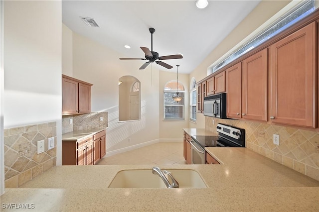 kitchen with tasteful backsplash, ceiling fan, sink, and electric range