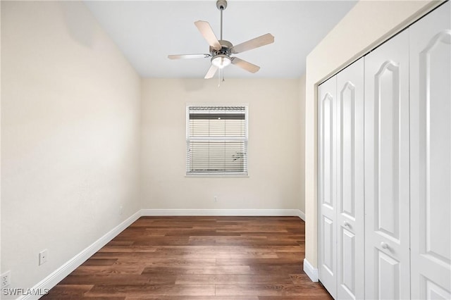 unfurnished bedroom with ceiling fan, dark hardwood / wood-style flooring, and a closet