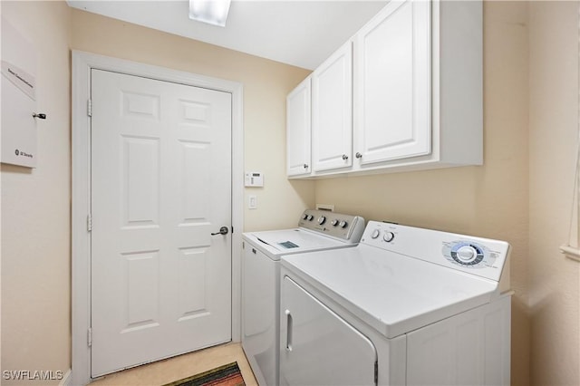 laundry area featuring cabinets and washer and dryer