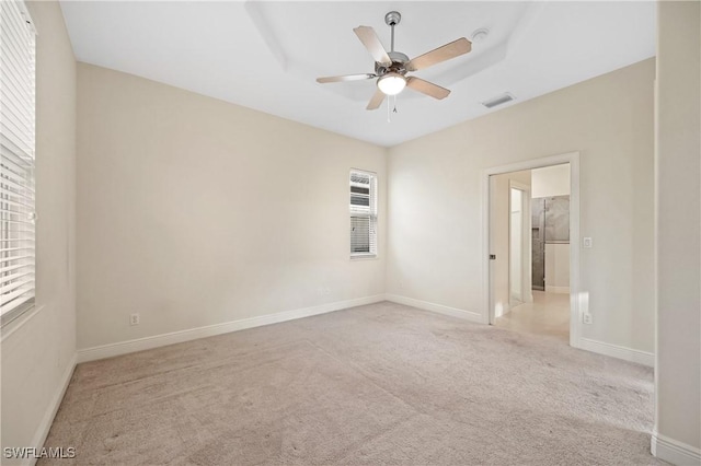 carpeted spare room with ceiling fan