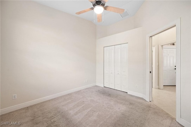 unfurnished bedroom with ceiling fan, a closet, and light carpet