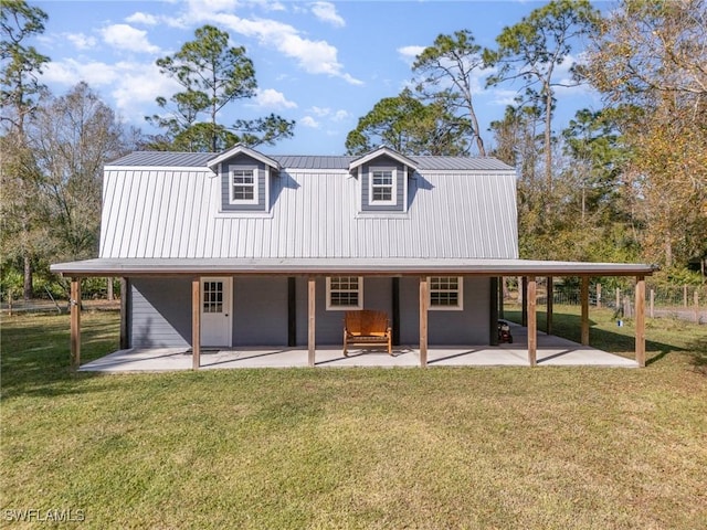 rear view of property featuring a yard and a patio area