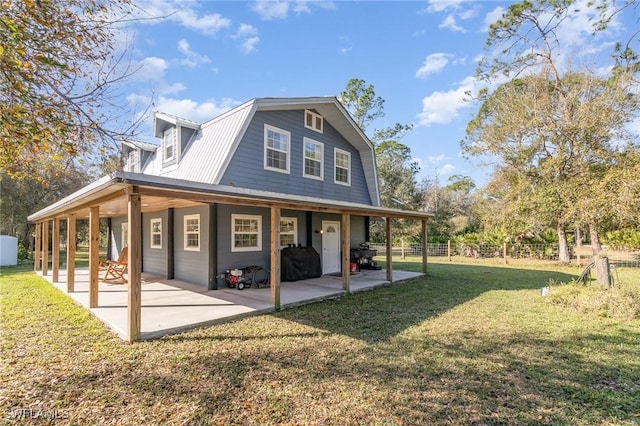 back of house featuring a patio area and a lawn