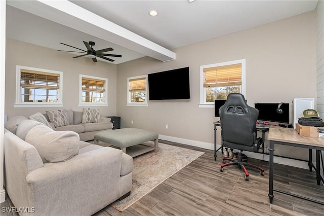 office area featuring ceiling fan, wood-type flooring, and beam ceiling