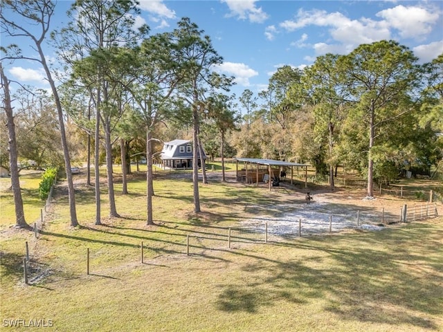 surrounding community featuring a rural view and a lawn