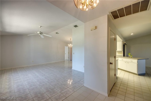 spare room featuring lofted ceiling, ceiling fan with notable chandelier, and light tile patterned floors