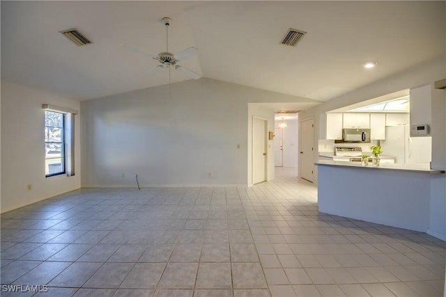 unfurnished living room featuring vaulted ceiling, light tile patterned floors, and ceiling fan