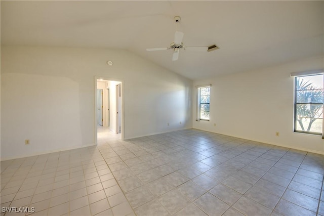 tiled spare room with ceiling fan, lofted ceiling, and a healthy amount of sunlight