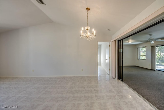 empty room featuring ceiling fan with notable chandelier and vaulted ceiling