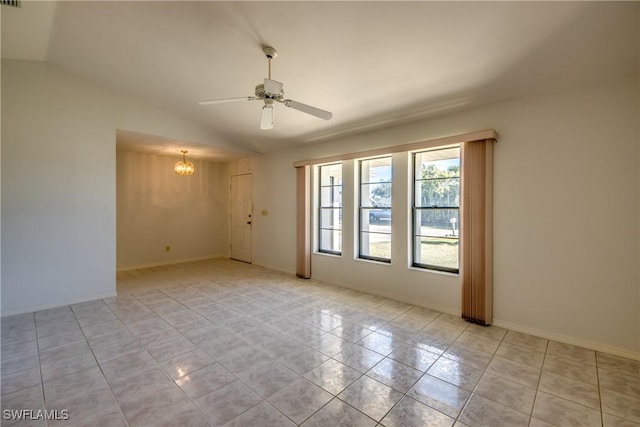 empty room featuring lofted ceiling, ceiling fan with notable chandelier, and light tile patterned floors