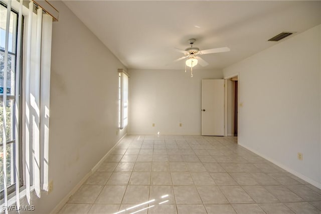 tiled empty room with ceiling fan