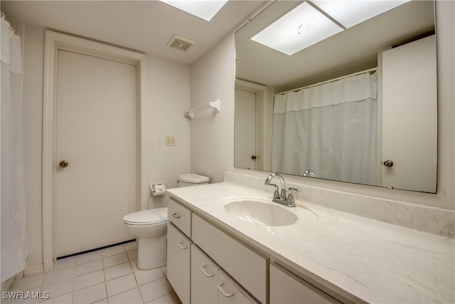 bathroom featuring tile patterned flooring, vanity, and toilet