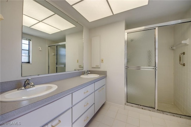 bathroom with vanity, an enclosed shower, and tile patterned floors