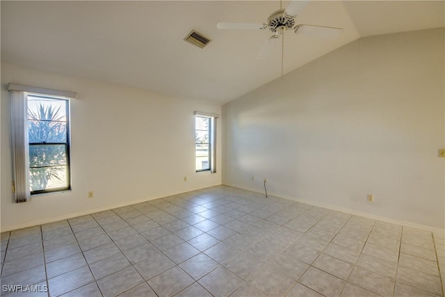 spare room with lofted ceiling, light tile patterned floors, and ceiling fan