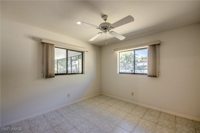 unfurnished room with light tile patterned floors and ceiling fan