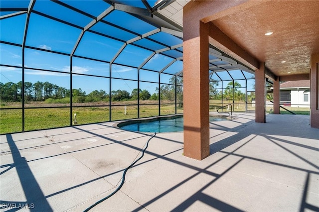 view of swimming pool featuring a yard, a patio, and glass enclosure