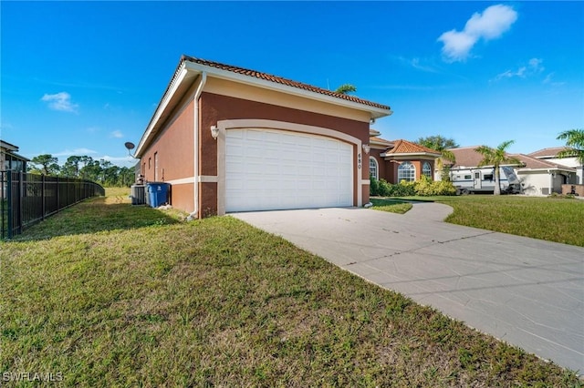 view of side of property featuring a garage and a yard