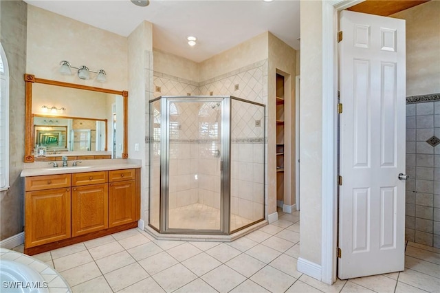 bathroom featuring walk in shower, tile patterned floors, and vanity