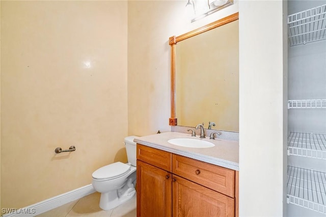 bathroom featuring vanity, tile patterned floors, and toilet