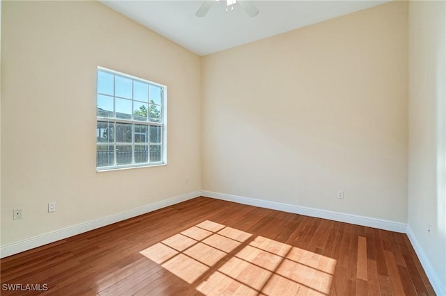 empty room with ceiling fan and wood-type flooring