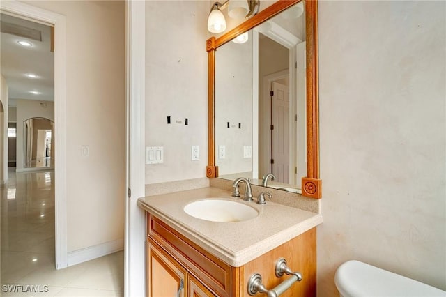 bathroom with vanity, tile patterned flooring, and toilet