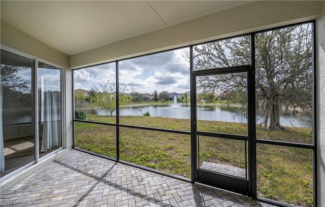 unfurnished sunroom with a water view