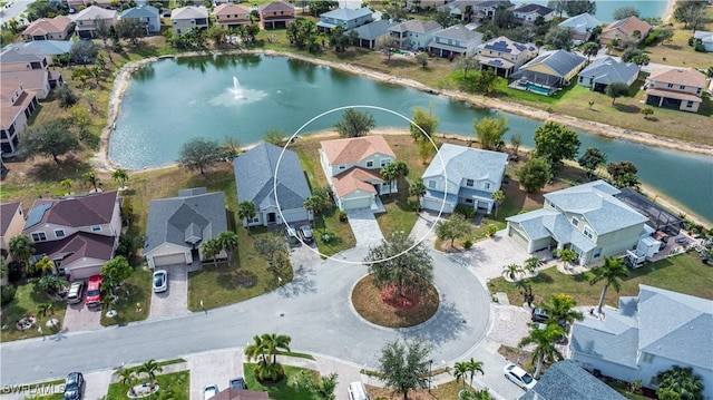 birds eye view of property with a water view and a residential view