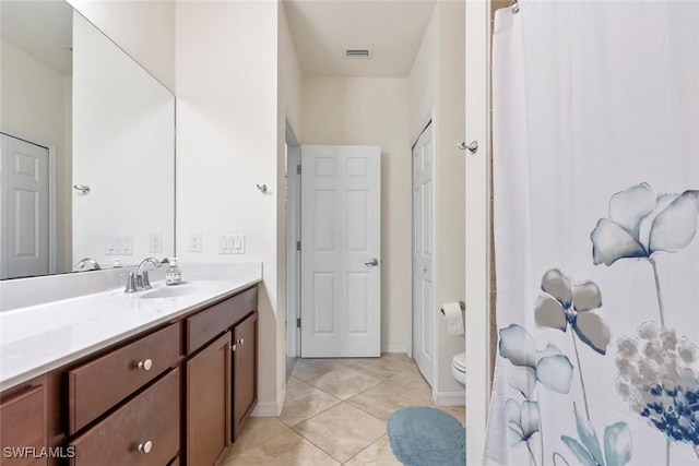 bathroom with vanity, tile patterned floors, and toilet