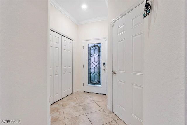 entryway featuring crown molding and light tile patterned flooring