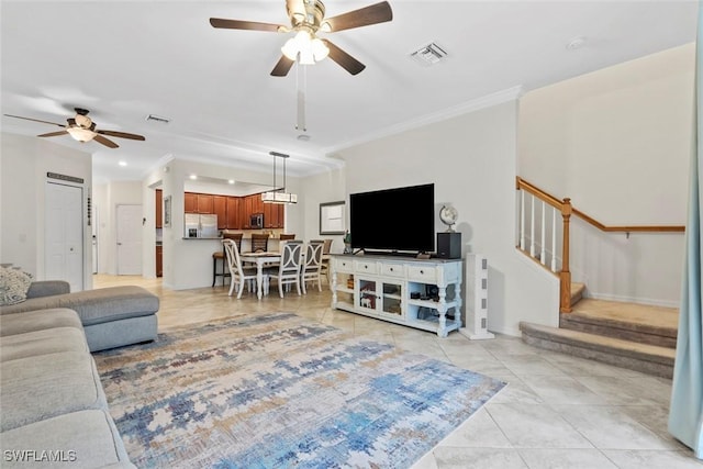 living room featuring crown molding, light tile patterned floors, and ceiling fan