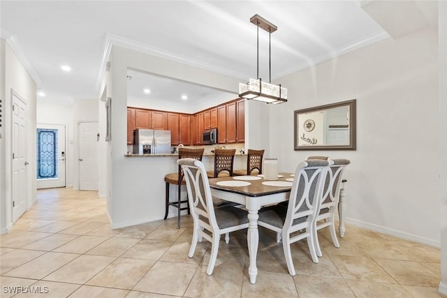 tiled dining area featuring ornamental molding