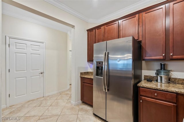 kitchen with light tile patterned floors, ornamental molding, light stone countertops, and stainless steel refrigerator with ice dispenser