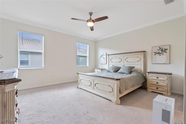 bedroom featuring ornamental molding, light colored carpet, and ceiling fan