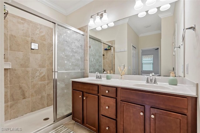 bathroom with crown molding, vanity, tile patterned flooring, and a shower with door