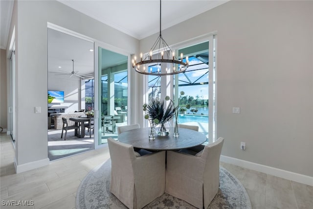 dining space featuring crown molding and ceiling fan with notable chandelier