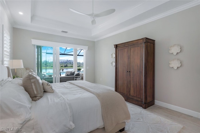 bedroom with a raised ceiling, ornamental molding, access to exterior, and ceiling fan