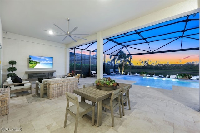 view of swimming pool featuring a water view, an outdoor hangout area, a patio area, and a lanai