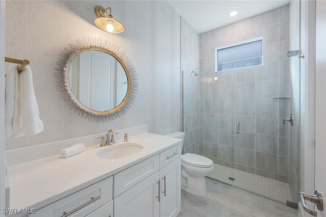 bathroom with vanity, an enclosed shower, and toilet