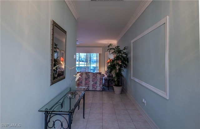 hallway featuring ornamental molding and light tile patterned flooring