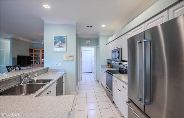 9269 Coach House Ln, Estero, FL 33928 - kitchen featuring visible vents, crown molding, light countertops, a sink, and appliances with stainless steel finishes