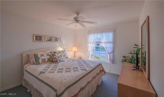 bedroom featuring ceiling fan and dark carpet