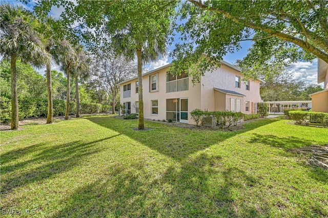 rear view of house with a lawn