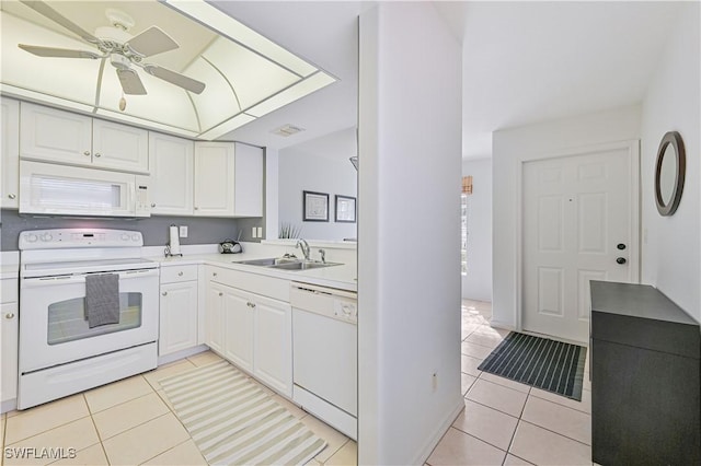 kitchen with white cabinetry, white appliances, sink, and light tile patterned floors