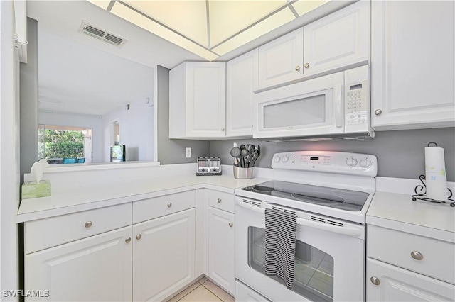 kitchen featuring white cabinetry and white appliances