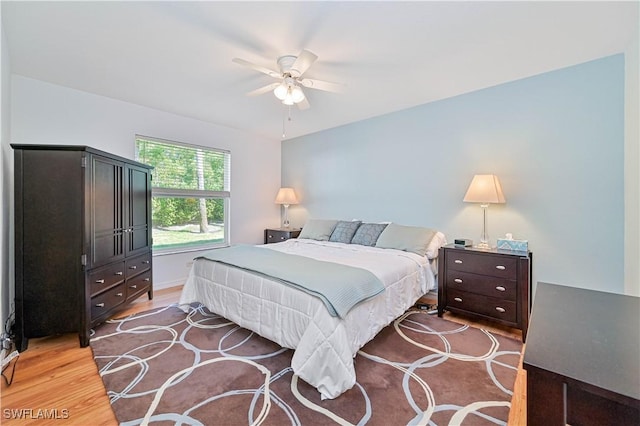 bedroom with light hardwood / wood-style floors and ceiling fan