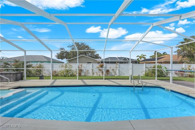 view of swimming pool with a lanai and a patio