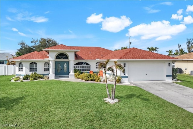 view of front of house featuring central AC, a garage, and a front yard