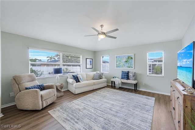 living room featuring ceiling fan, hardwood / wood-style flooring, and a healthy amount of sunlight