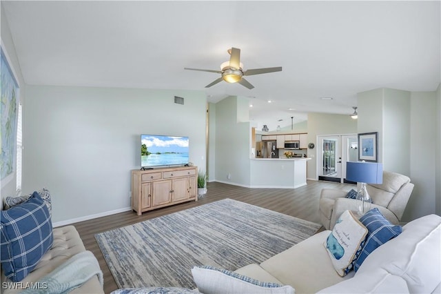 living room featuring vaulted ceiling, dark wood-type flooring, ceiling fan, and french doors