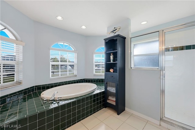 bathroom with shower with separate bathtub and tile patterned floors